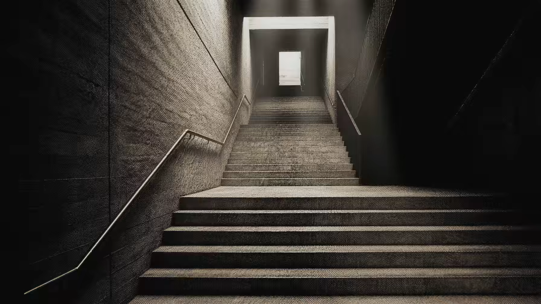 Grabado: una escalinata que sube hacia una puerta iluminada.