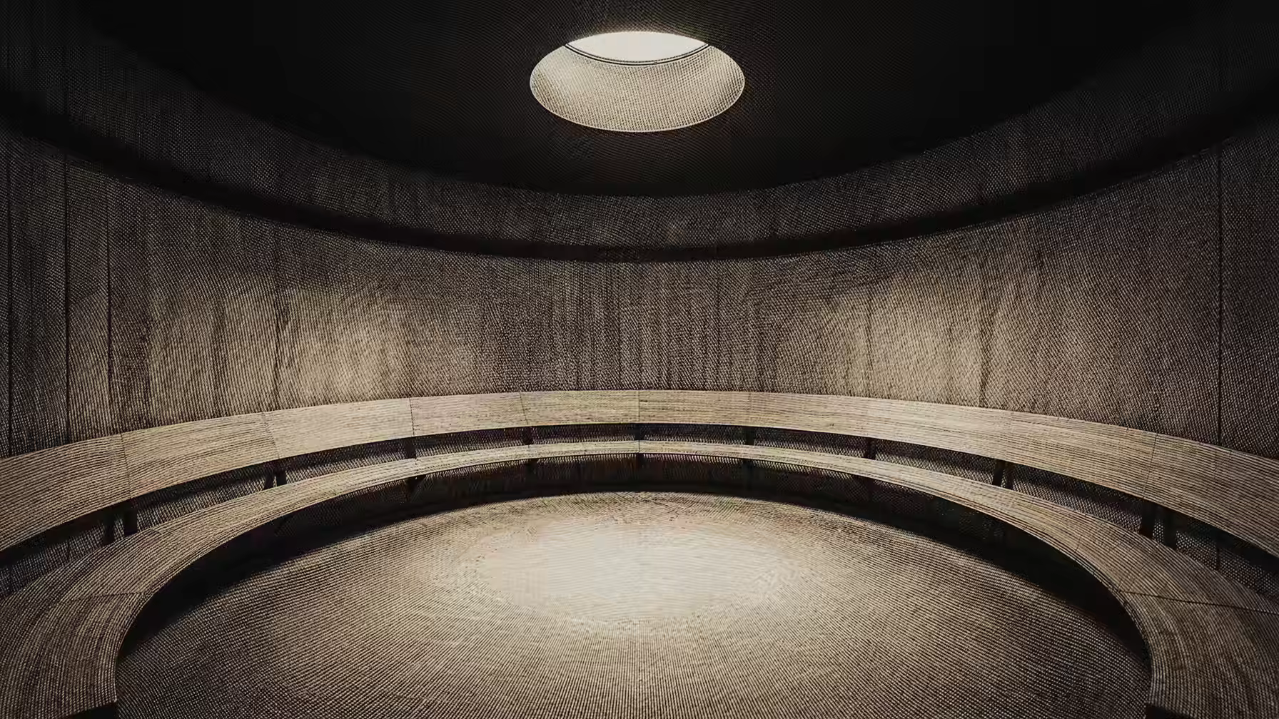 Grabado: una sala circular con bancada y un óculo de luz en el techo.